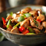 A close-up view of a colorful chicken stir fry with vibrant vegetables.