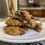 An appealing side profile of peanut butter chocolate chip oatmeal cookies, showcasing their chewy consistency and rich ingredients.