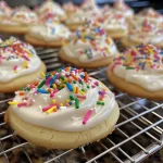 Detailed view of thick royal icing dripped from a spatula, ready for cookie decoration.