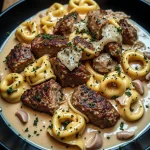 Delicious garlic steak tortellini served in a creamy sauce and garnished with fresh parsley.