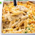 Gluten-free chicken Alfredo bake being served with a spatula.