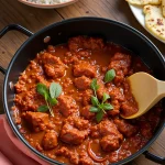 Lighter Chicken Tikka Masala served in a pan with rice and naan bread.