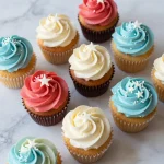 A colorful flag cupcake decorated with red, white, and blue frosting