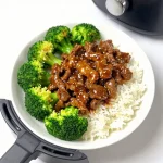 A delicious plate of air fryer beef and broccoli served with rice