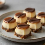 Close-up of easy no-bake salted caramel pretzel cheesecake bites on a serving tray.