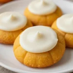 A plate of soft and fluffy pumpkin cookies topped with a drizzle of icing.