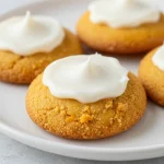 A plate of gluten-free pumpkin pie cookies topped with Greek yogurt cream cheese frosting.