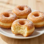 Freshly baked apple cider donuts on a wooden table