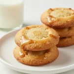 A plate of pumpkin oatmeal cookies topped with a drizzle of browned butter icing