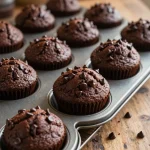 Freshly baked double chocolate zucchini muffins on a cooling rack