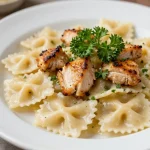 A delicious bowl of creamy chicken bowtie pasta garnished with parsley